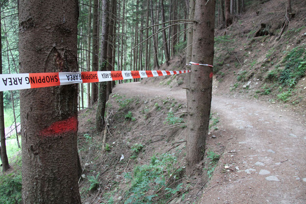 Photo of Outdoor Intervention in Schwaz, Anarchy Now, 2011, Installation, scaleable, video, printed caution tape, acrylic on printed wallpaper (250 x 320 cm), Artist Jürgen Bauer