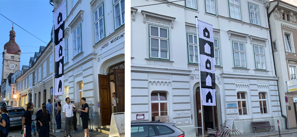 Exhibition opening Artcard project stadtgalerie raumimpuls waidhofen with a flag by artist Jürgen Bauer